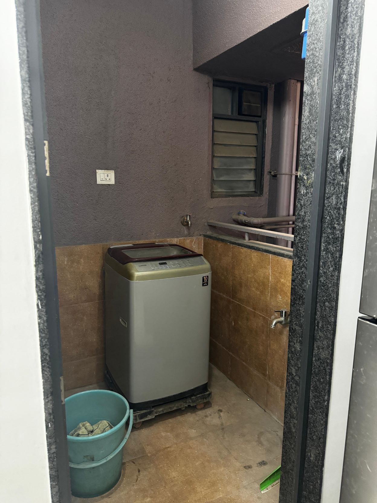 Separate utility space for washing machine and laundry.