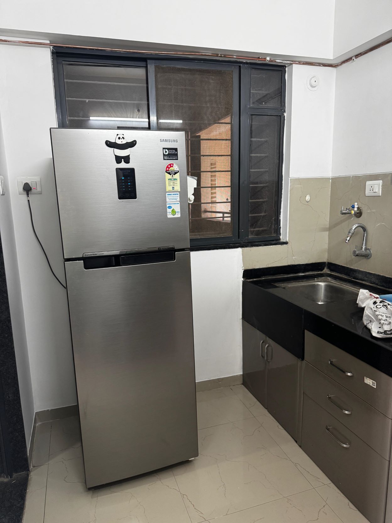 Apartment comes with essential appliances including refrigerator.